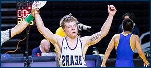 Wrestler Poulin raising his hands after winning match