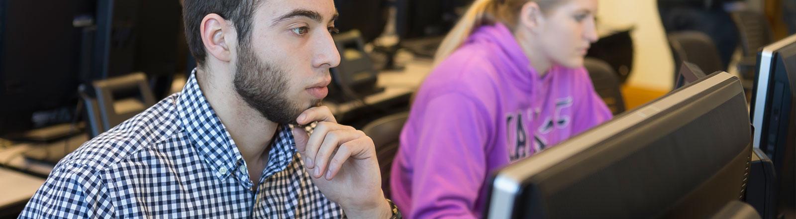 Student deep in thought at computer